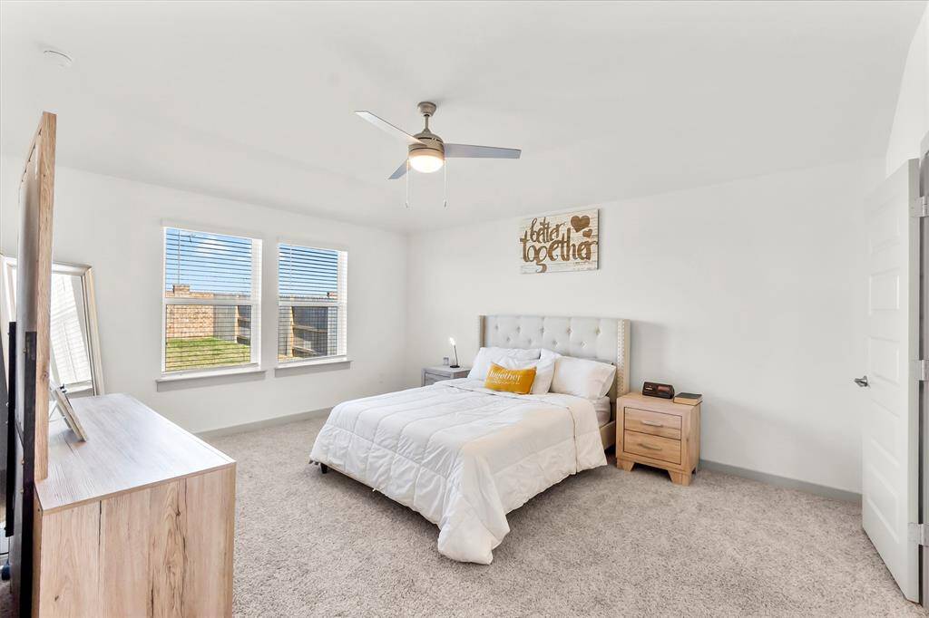 Primary bedroom tuck to the back of the house with windows for natural lighting