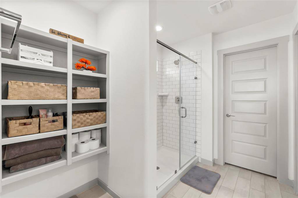 Large ensuite with designated linen area, oversize shower, enclosed water closet and large walk-in closet