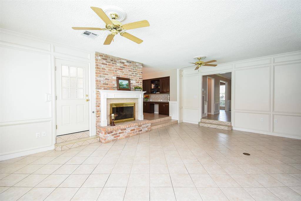 Even in 1973, when the home was first built, convenience, comfort and practicality were prime considerations that would, indeed, span decades. One gorgeous example is the built-in, stone surrounded wood burning fireplace, as a delightful showplace featured in this vast living area.