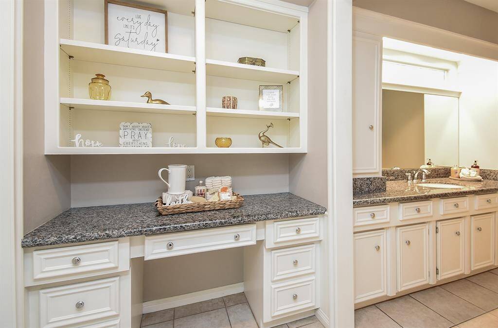 Bright, welcoming, and spacious, the primary ensuite bath features good looking granite counter tops /vanity, white cabinetry, and a gleaming wall-wide mirror, all positioned for comfort and convenience.