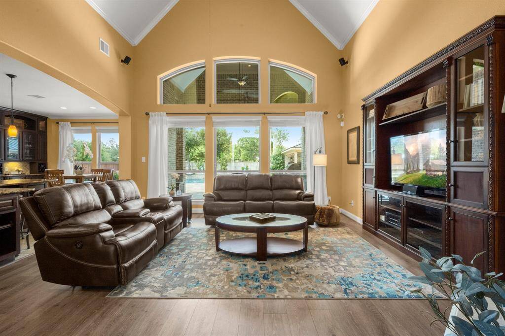 Floor-to-ceiling windows frame the stunning outdoor escape. Open-concept living with cozy fireplace and custom built-ins.