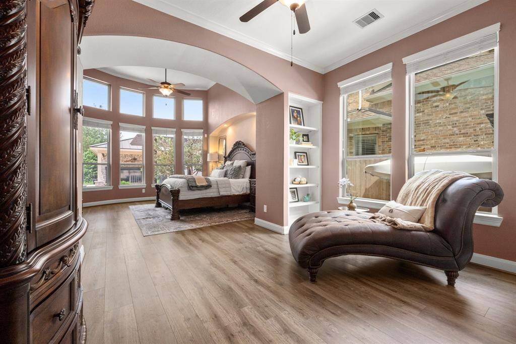 The oversized primary bedroom is a true retreat, featuring a spacious sitting area perfect for morning coffee or evening unwinding.