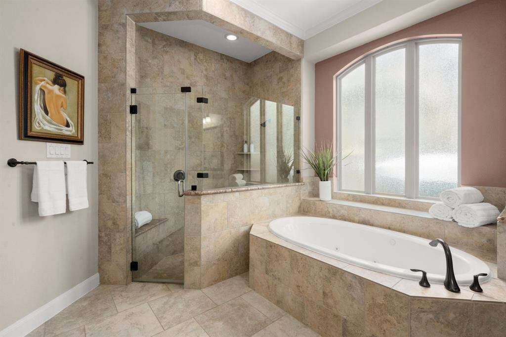The oversized, step-in shower boasts elegant tile work and room to truly unwind.