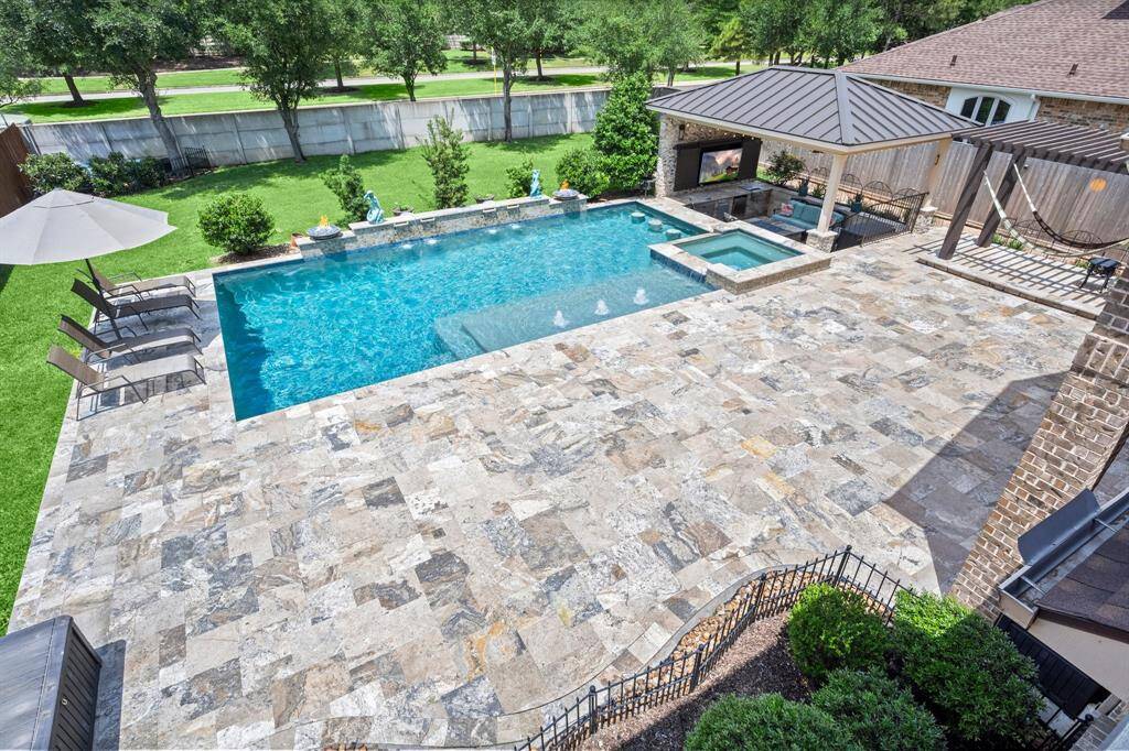 View of the pool and backyard from the upstairs balcony.