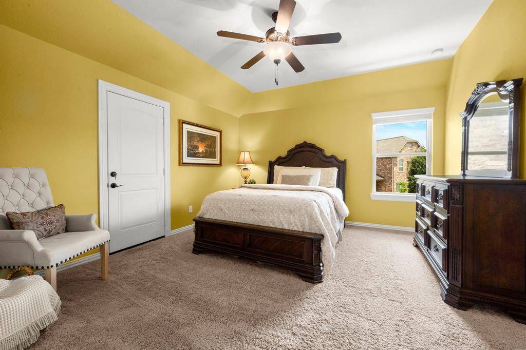 Spacious bedrooms with ample closet space and natural light, with ceiling fans and blinds on the windows.