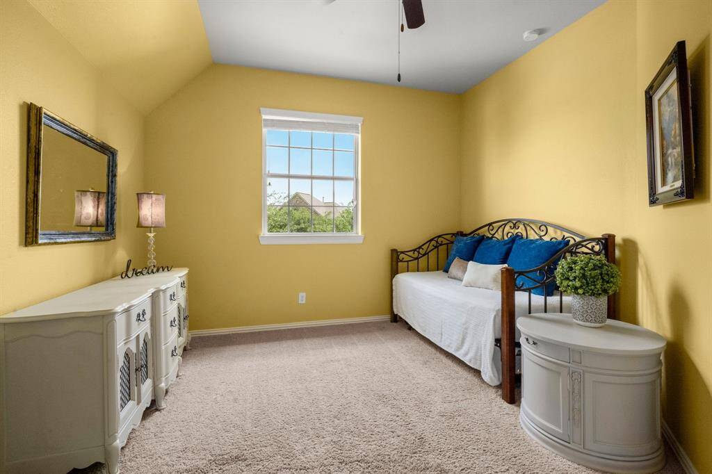 Spacious bedrooms with ample closet space and natural light, complete with a ceiling fan, walk-in closet and blinds.