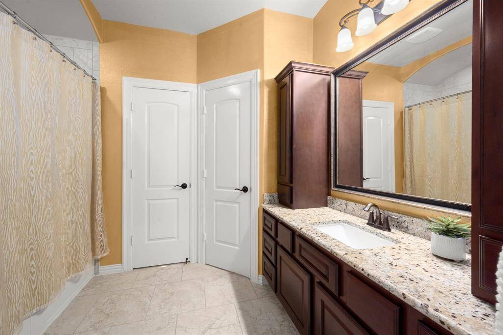 Full bathroom just off of the guest suite with a shower and vanity with lots of cabinet storage.