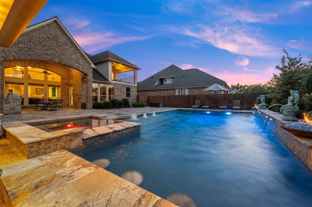 Lounge in the sunken living area nestled within the pool, complete with a swim-up bar, in-pool barstools, and a mounted outdoor TV that stays!