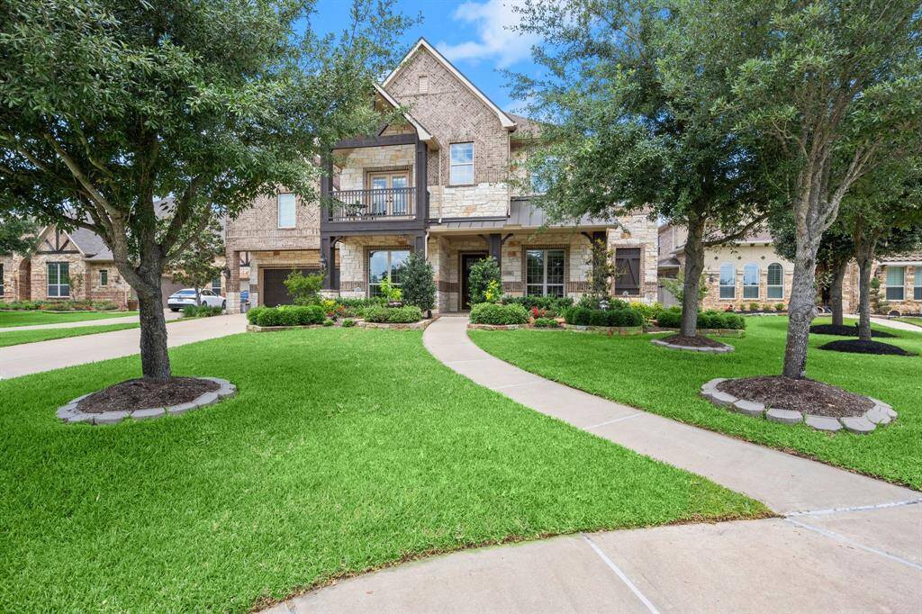 Welcoming curb appeal with lush greenery and classic design touches.