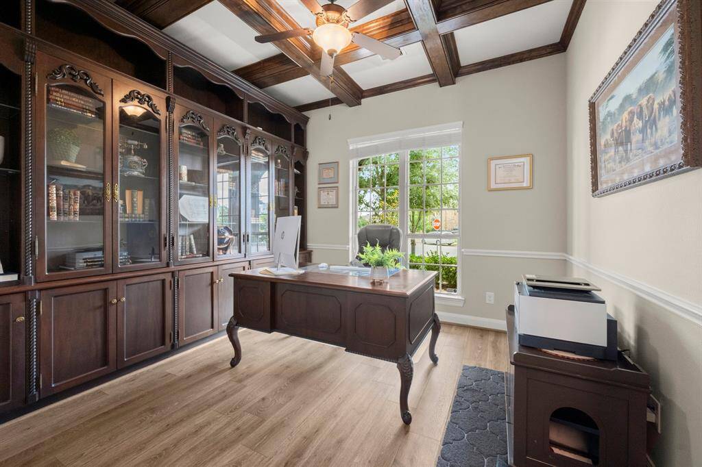 Rich mahogany built-ins elevate this executive home office. Quiet and private—ideal for working or relaxing with a book.