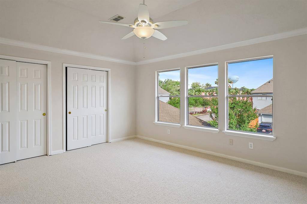 Spacious upstairs primary bedroom with abundant natural light.