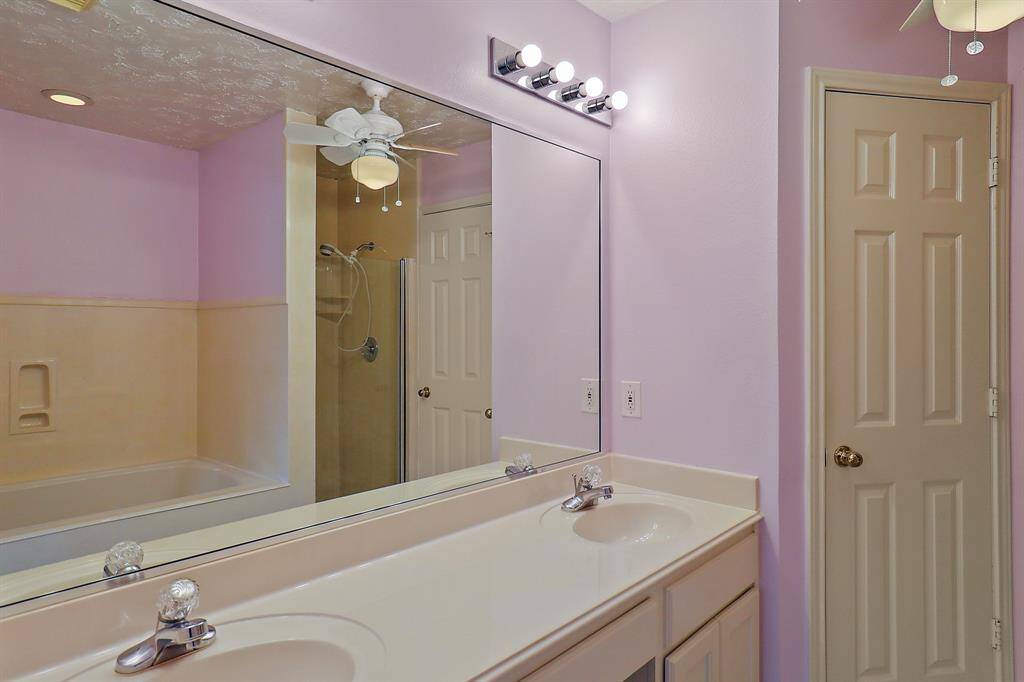 Spacious upstairs primary bathroom with a double vanity and modern fixtures.