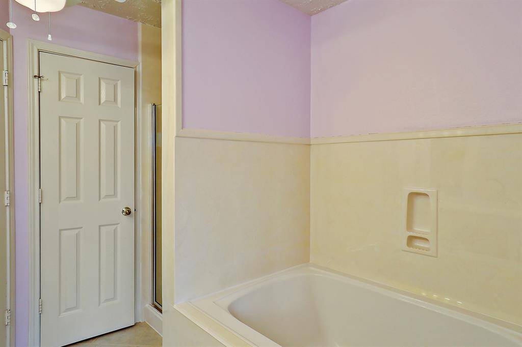 Luxurious bathtub in the serene upstairs primary bathroom.