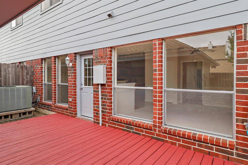 Spacious back porch perfect for relaxing and entertaining.