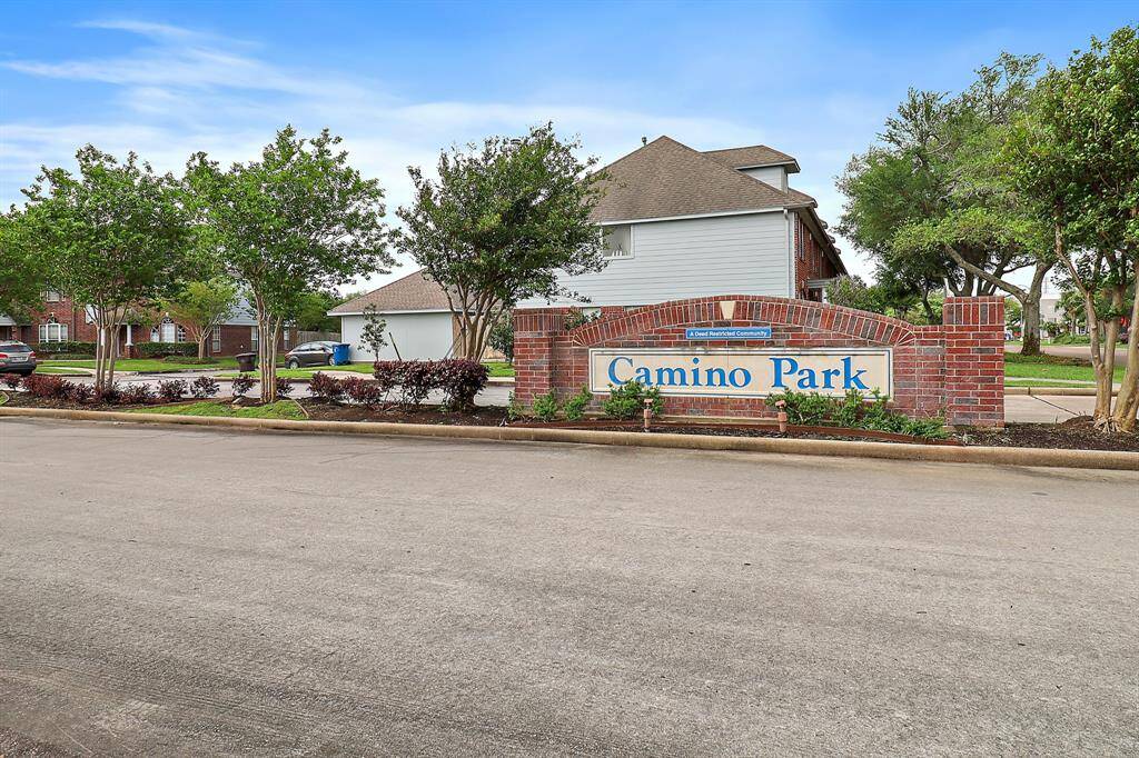 Welcome to Camino Park: a charming, well-maintained community with inviting streets and lush greenery.