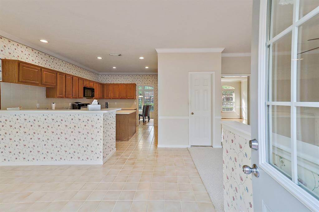 Elegant entryway leading directly into a spacious kitchen.