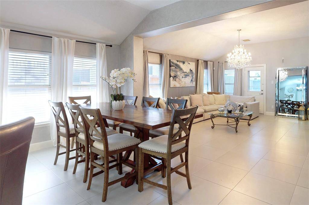 Natural light streams in through multiple windows, enhancing the airy and inviting ambiance.