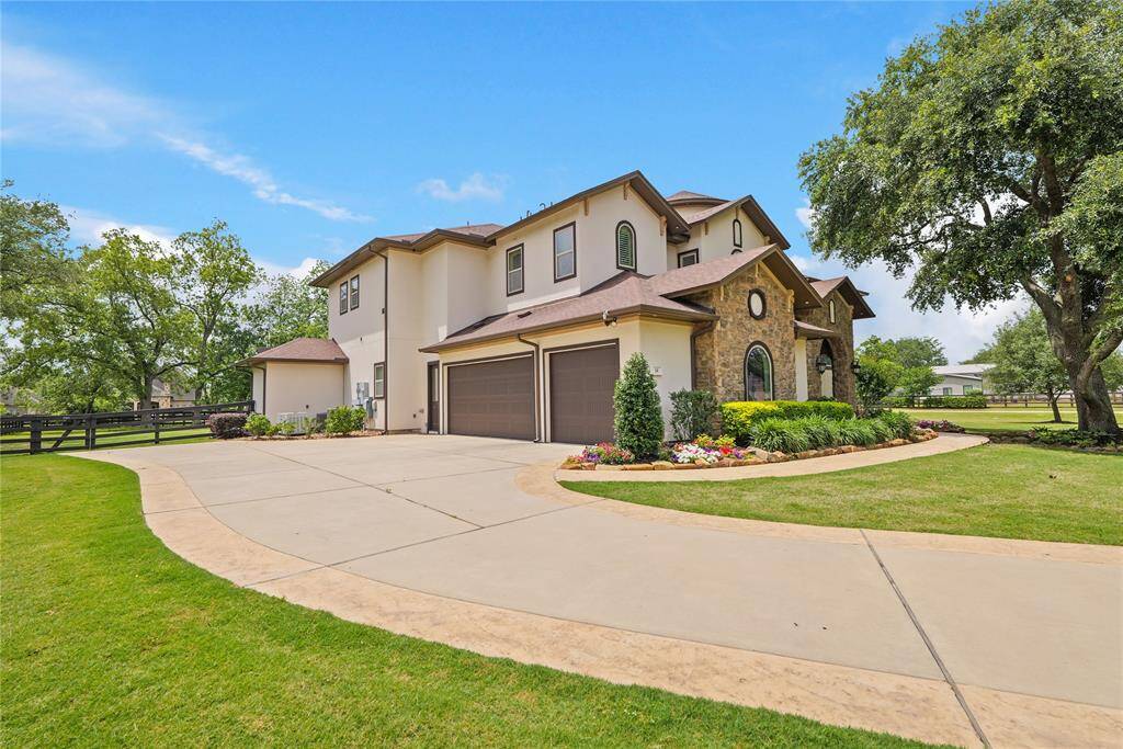 Stunning curb appeal and a spacious three-car garage welcome you to this beautifully landscaped, custom-designed home nestled on a peaceful, tree-lined lot.