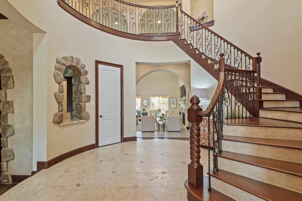 Step into a Grand Entryway with a stunning spiral staircase that sets the tone for the home’s elegance.