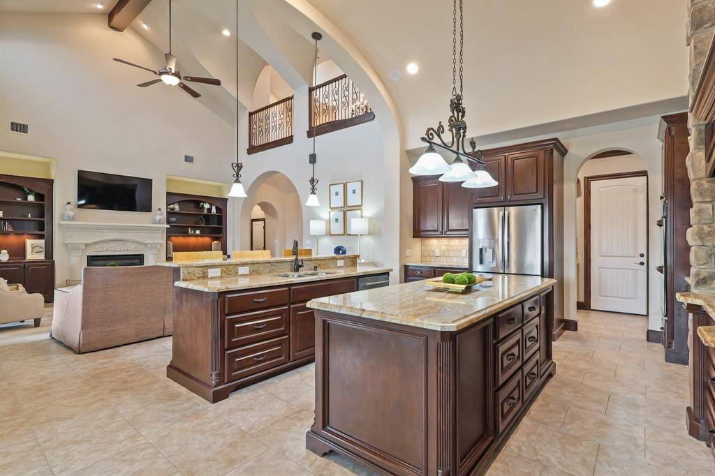 The spacious Kitchen, with its large island, is designed for both function and style, offering an open-concept layout that makes cooking and entertaining a breeze.