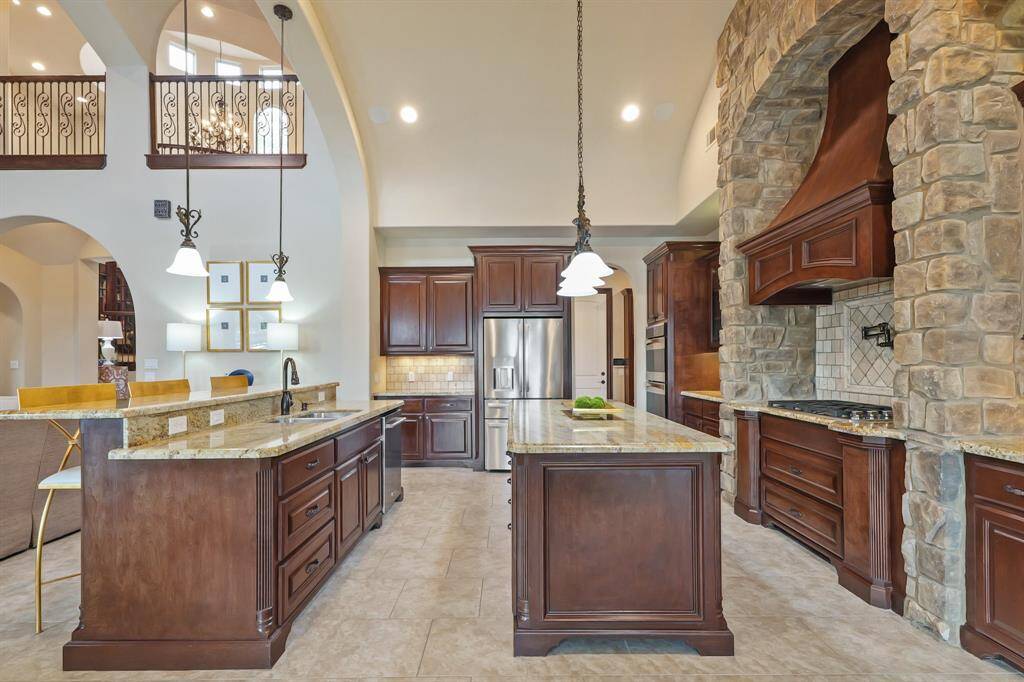 The Kitchen features elegant granite countertops, stainless appliances, and custom cabinetry, providing a perfect blend of form and function for everyday living and hosting guests.