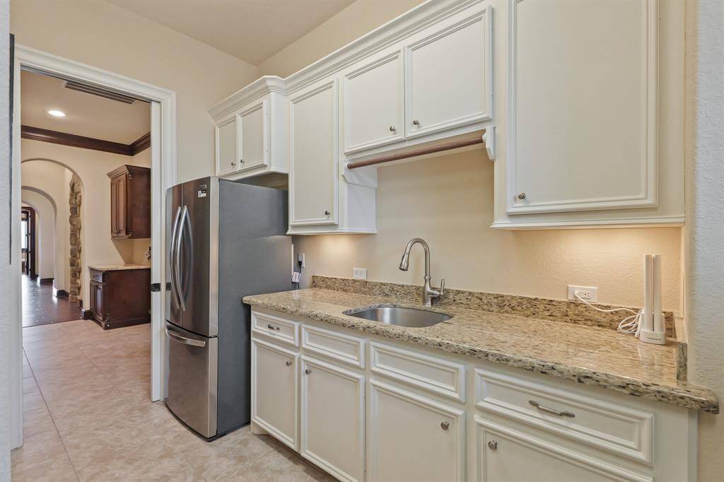 The thoughtful design in this large Utility Room ensures you have all the space you need to manage laundry, cleaning, and additional storage, along with a designated area for a refrigerator.
