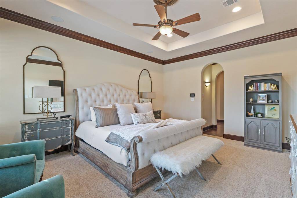 The Primary Suite offers a serene escape with coffered ceilings, an En-Suite Bathroom and a spacious walk-in his and hers closets.