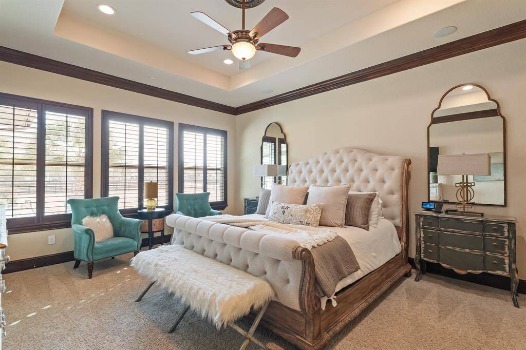 The spacious Primary Suite features private access to the backyard, elegant plantation shutters and large windows that frame beautiful views of the backyard, creating a tranquil retreat where you can relax in comfort.