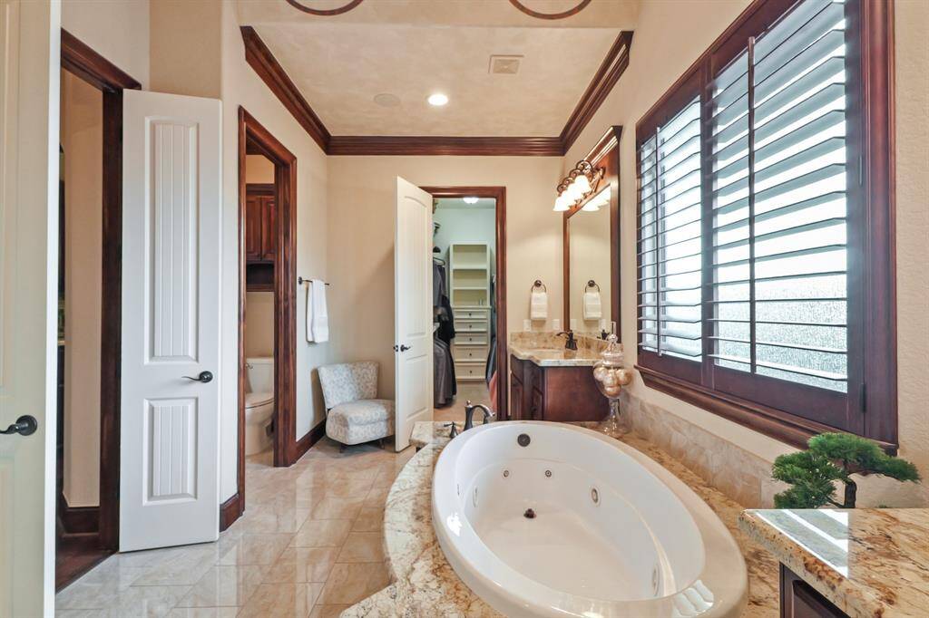 The En Suite Primary Bath offers a spa-inspired experience with high-end finishes, a spacious linen closet, and carefully chosen details that create a harmonious blend of function and elegance.