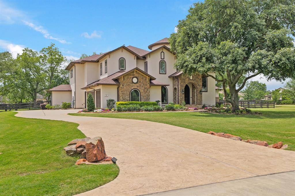 Step into the pinnacle of elegance at 14 Royal King Road, located in the prestigious Gated Equestrian Community of Willowcreek Ranch!