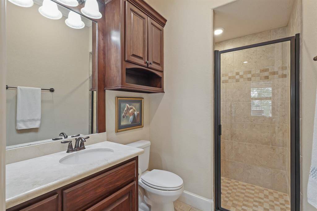 The En Suite Guest Bathroom is a serene space, complete with stylish tile work, a generous vanity, and a spacious shower, offering a comfortable retreat for guests with all the amenities they need.