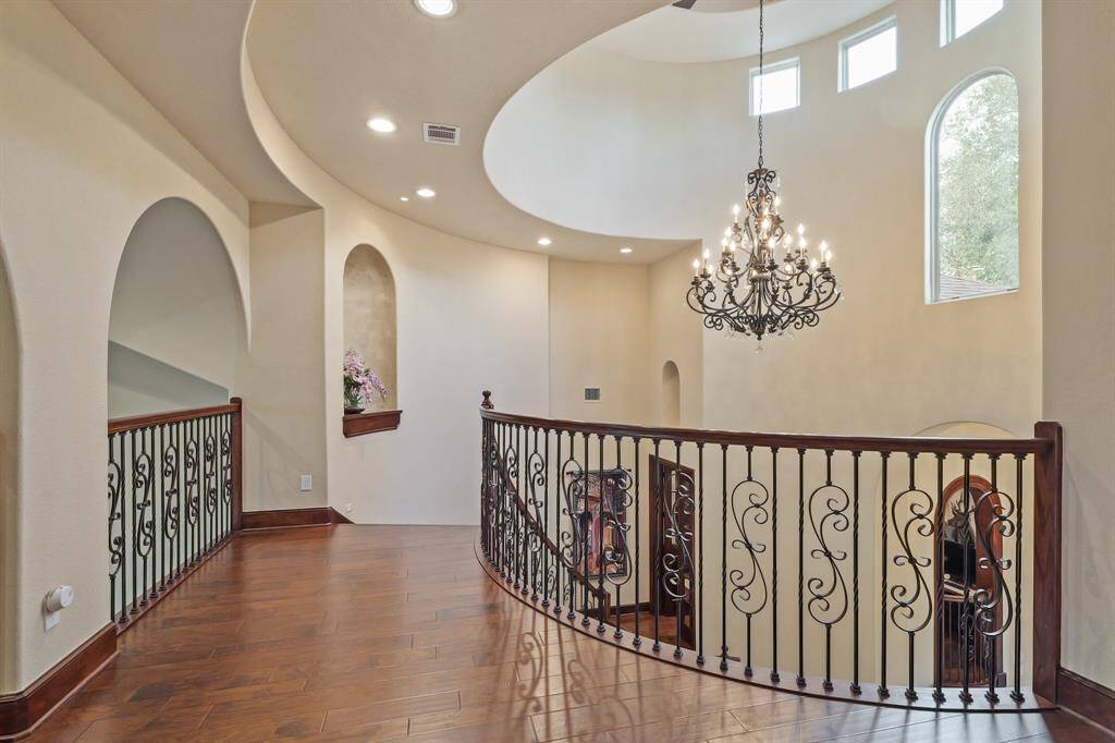With a breathtaking Chandelier as its centerpiece, the second-floor landing overlooks the first-floor Entryway and living areas, adding elegance and a sense of grandeur to the home’s design.