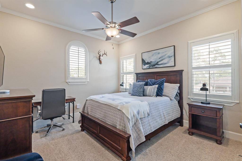 Bedroom #4 is a bright, welcoming space with large windows, crown molding, a spacious closet, and room for personalization, offering a perfect balance of comfort and practicality.