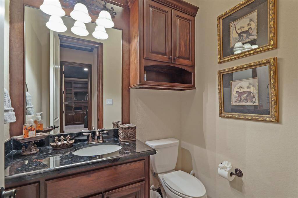 Conveniently located off the TV Room, the half bath offers easy access and added functionality for guests and family alike.