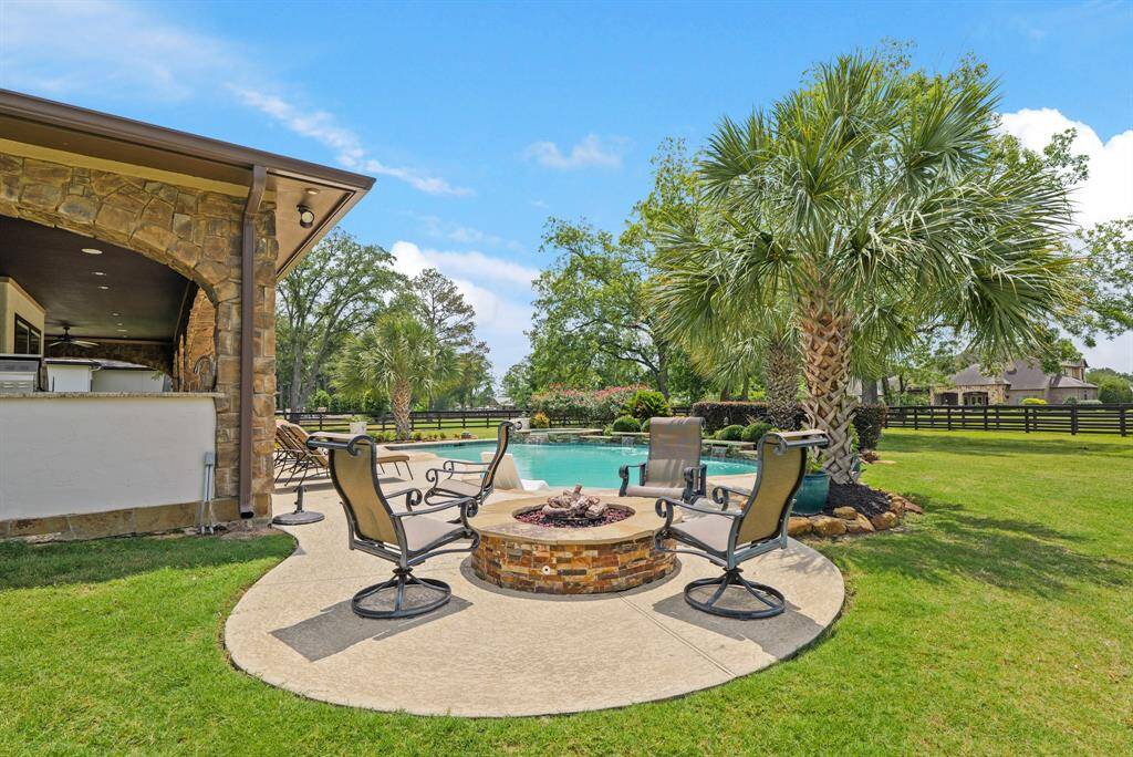 he spacious backyard oasis with a pool & spa is complemented by a spacious covered patio with an auto gas firepit— perfect for entertaining and creating a serene, private retreat.