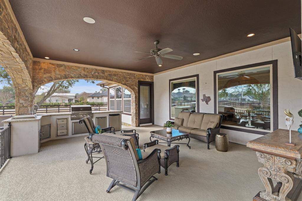 An entertainer’s dream, the Outdoor Kitchen features a built-in grill, mini refrigerator, built-in ice cooler, and wall-mounted TV. This luxurious space includes a spacious dining area with ceiling fans —perfect for hosting gatherings.