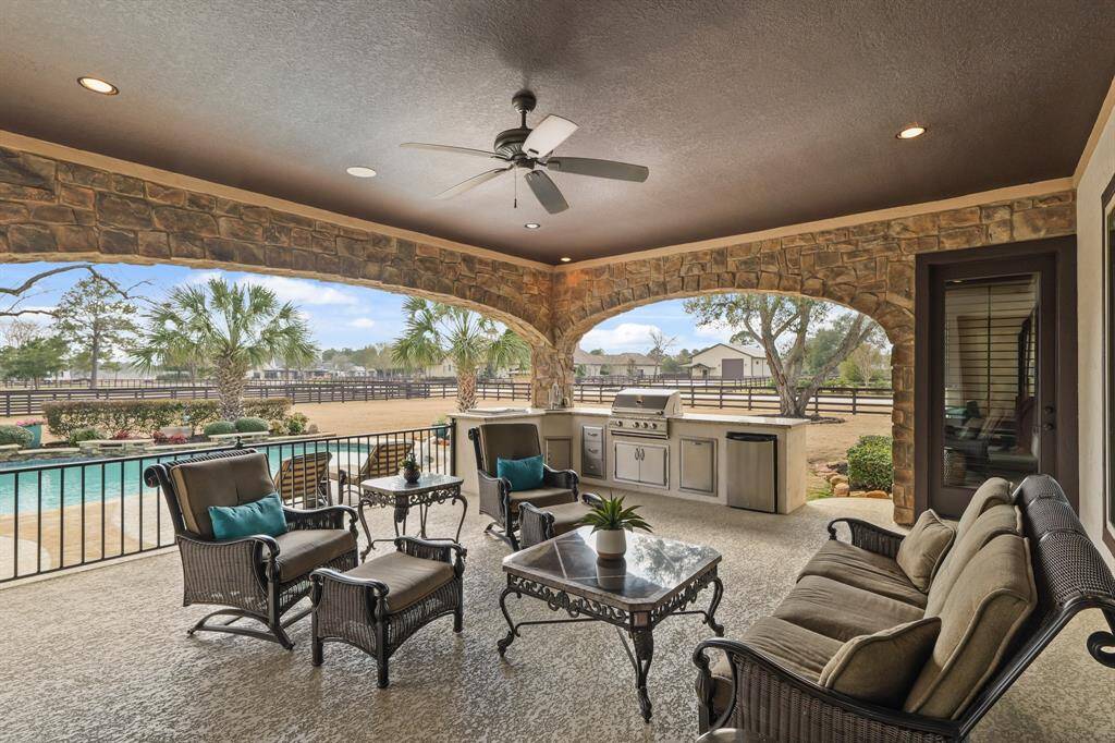 The Covered Patio overlooks the pool & spa and expansive backyard, offering the perfect space for relaxation and entertaining.