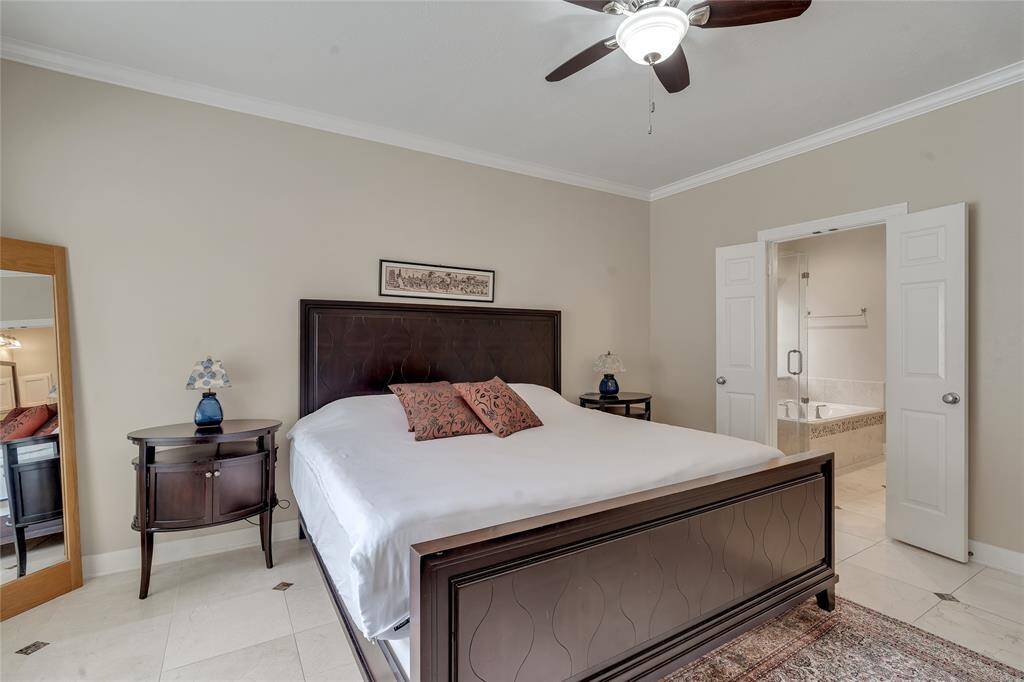 Another view of the primary bedroom, leading to the primary bathroom and a walk-in closet.