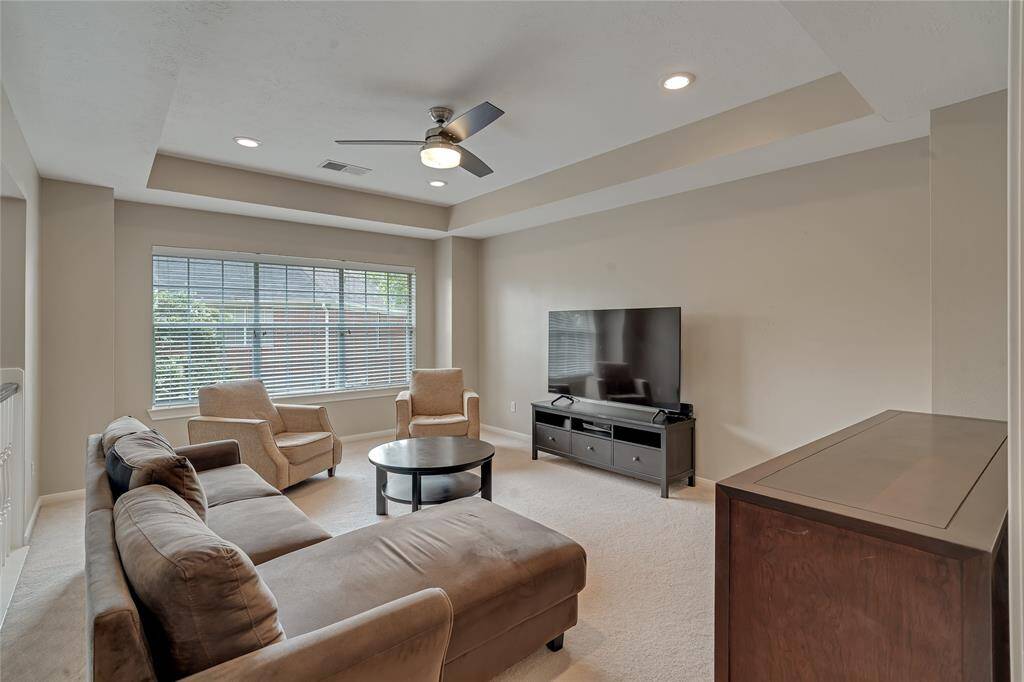The spacious gameroom has coffered ceilings and an updated ceiling fan.