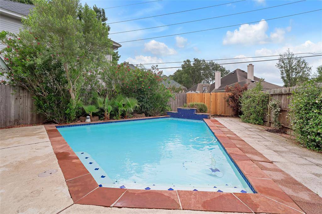 The pool has a waterfall feature and lush tropical landscaping. Perfect to cool off during the hot summer months.