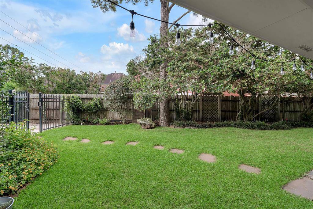 Another view of the backyard, beyond the wrought iron fence is the swimming pool.