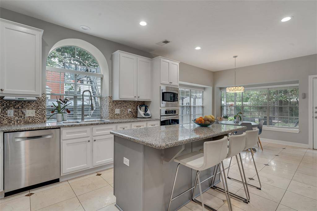 Stainless steel appliances, granite countertops, and under-cabinet lighting.