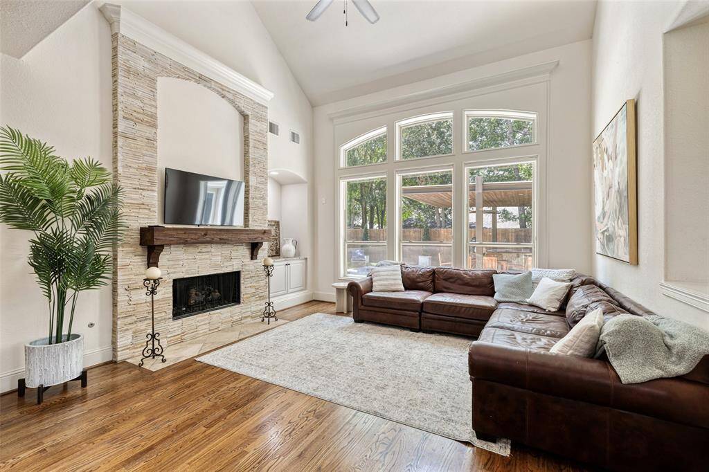 The family room features dramatic vaulted ceilings and is bathed by natural light and view of the back yard oasis.