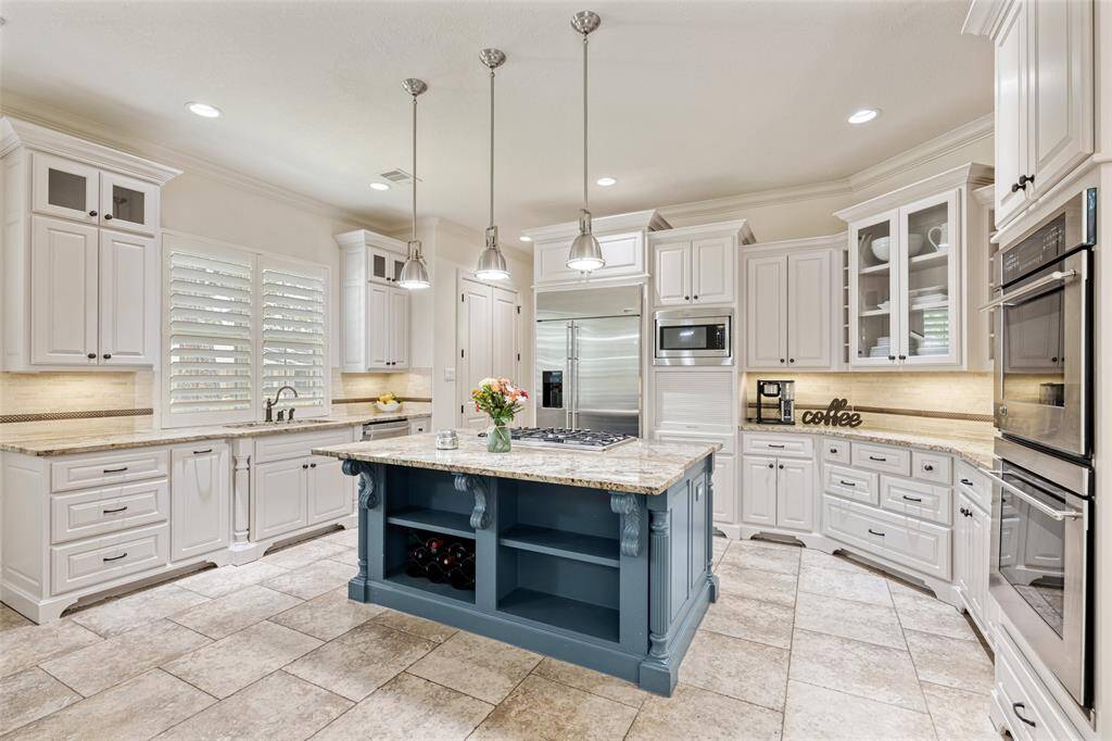 A chef's dream kitchen. Under cabinet lighting, double ovens and gas cooktop are conveniently located for food preparation and cooking that special meal.