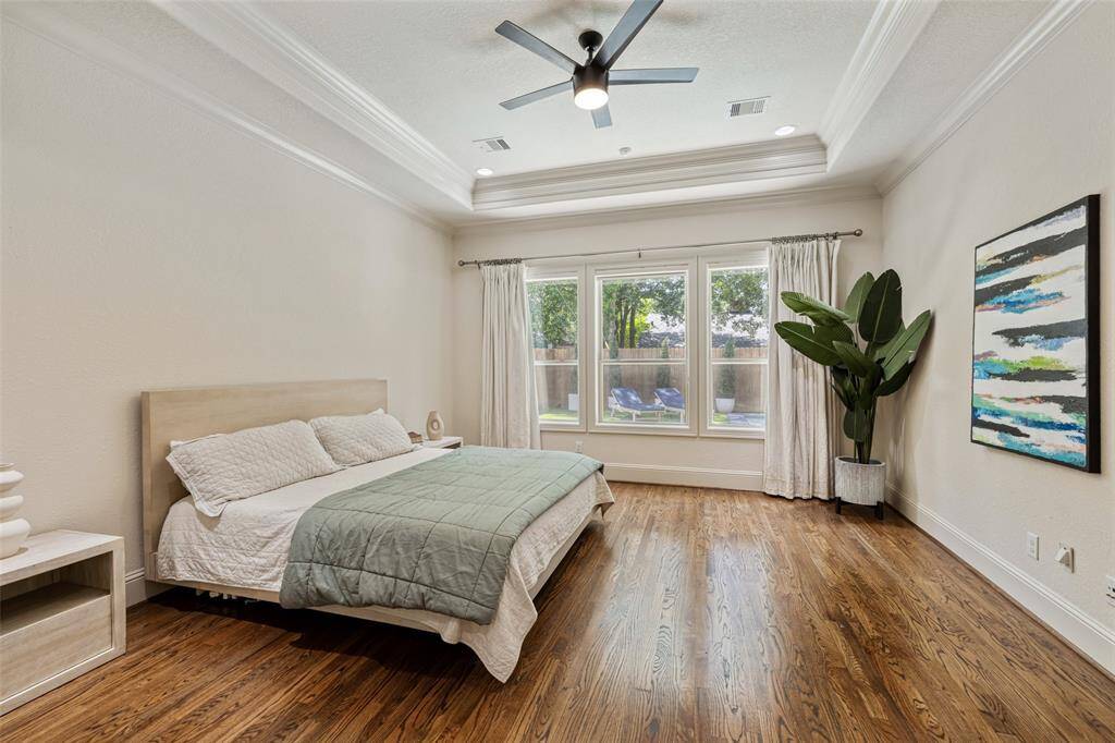 The spacious owners suite is both large and inviting and has a panoramic view of the pool and backyard.