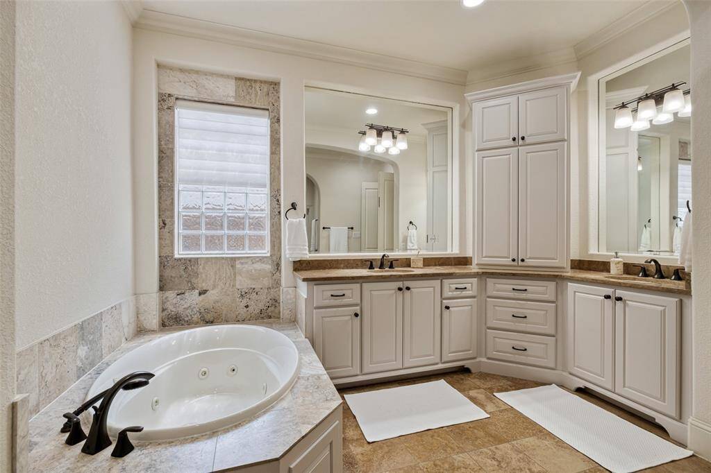 Luxuriate in the jetted tub. Dual vanities, and large storage spaces.
