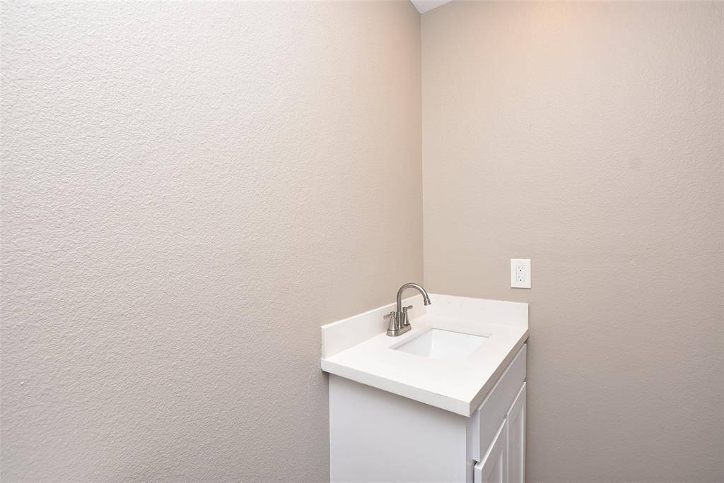 Half bathroom has freshly painted neutral walls!