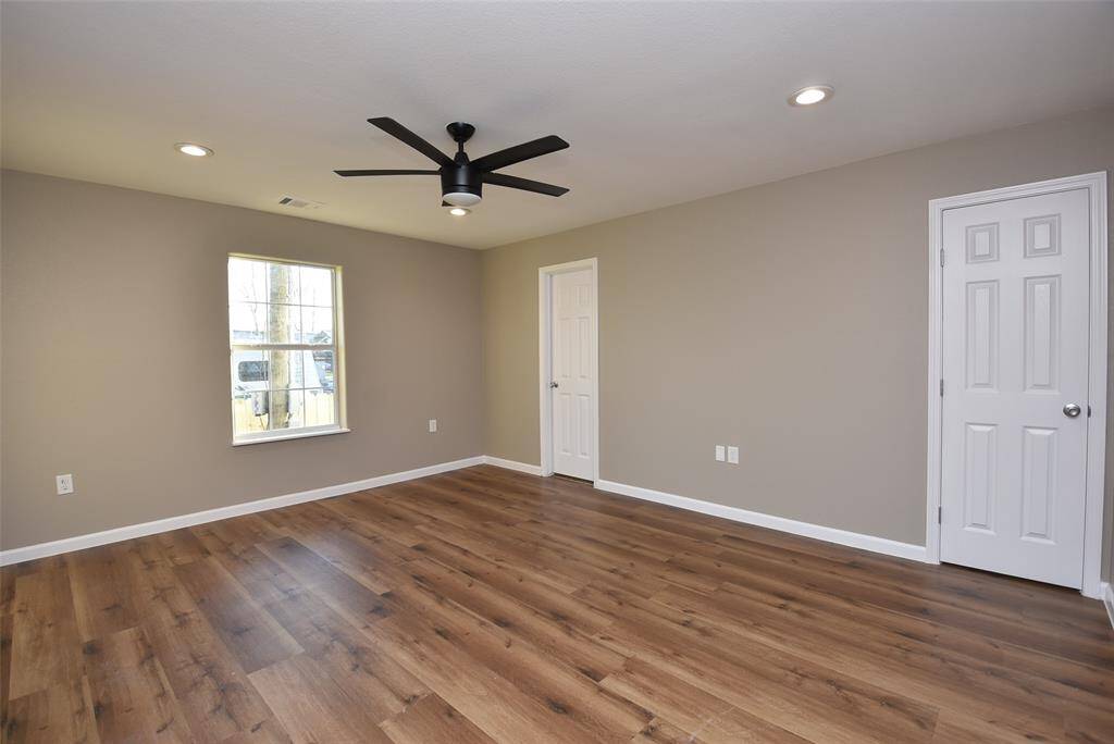 Bedroom #2 includes a ceiling fan and has freshly painted neutral walls.