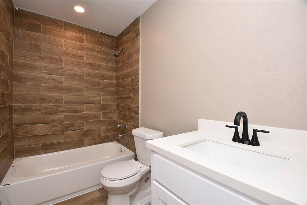 Bathroom #2 features a shower/tub combo with a gorgeous backsplash