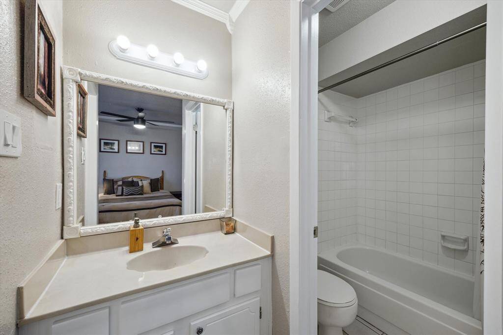 The secondary bedroom has ample space in this vanity area. And a shower/tub area that can be closed off for privacy.